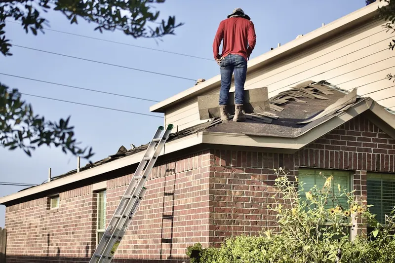 Professional roofer working on a residential roof in Four Lakes